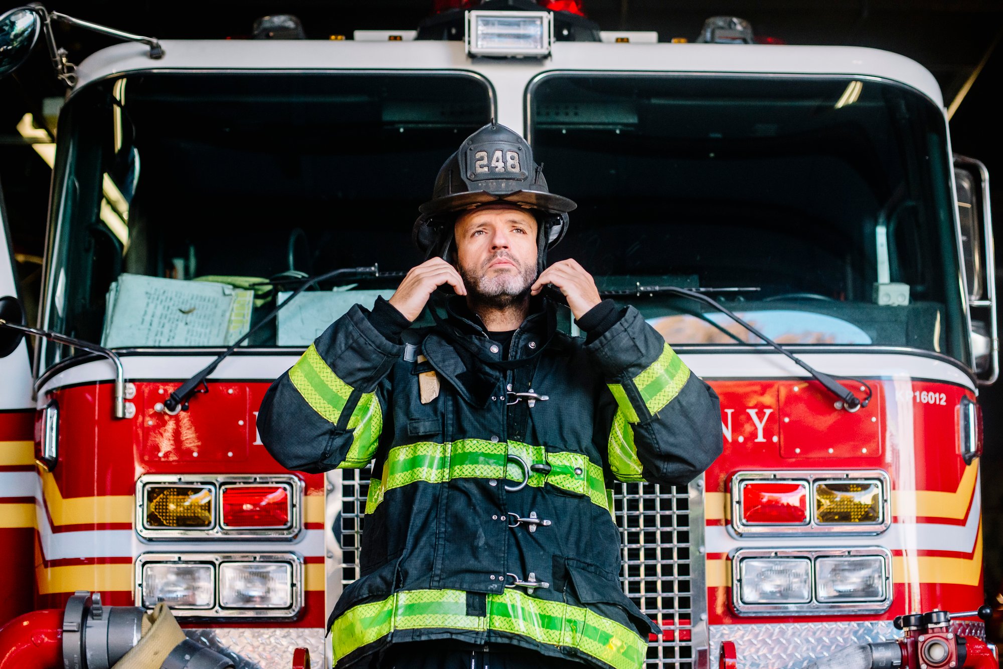 usa-new-york-portrait-of-firefighter-putting-on-2024-09-18-20-48-56-utc
